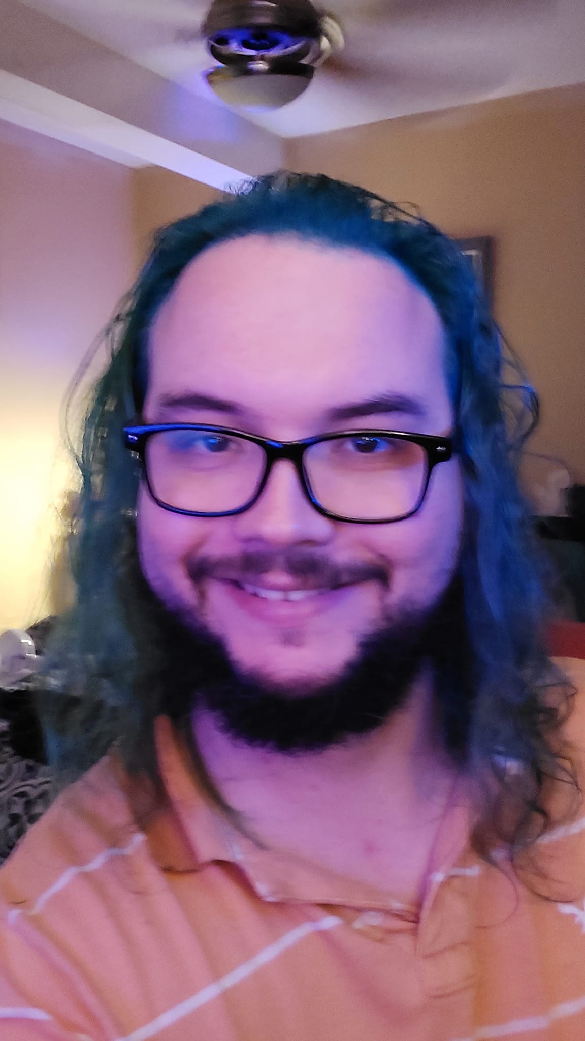 A man with long green hair sits in a computer chair, photo 3